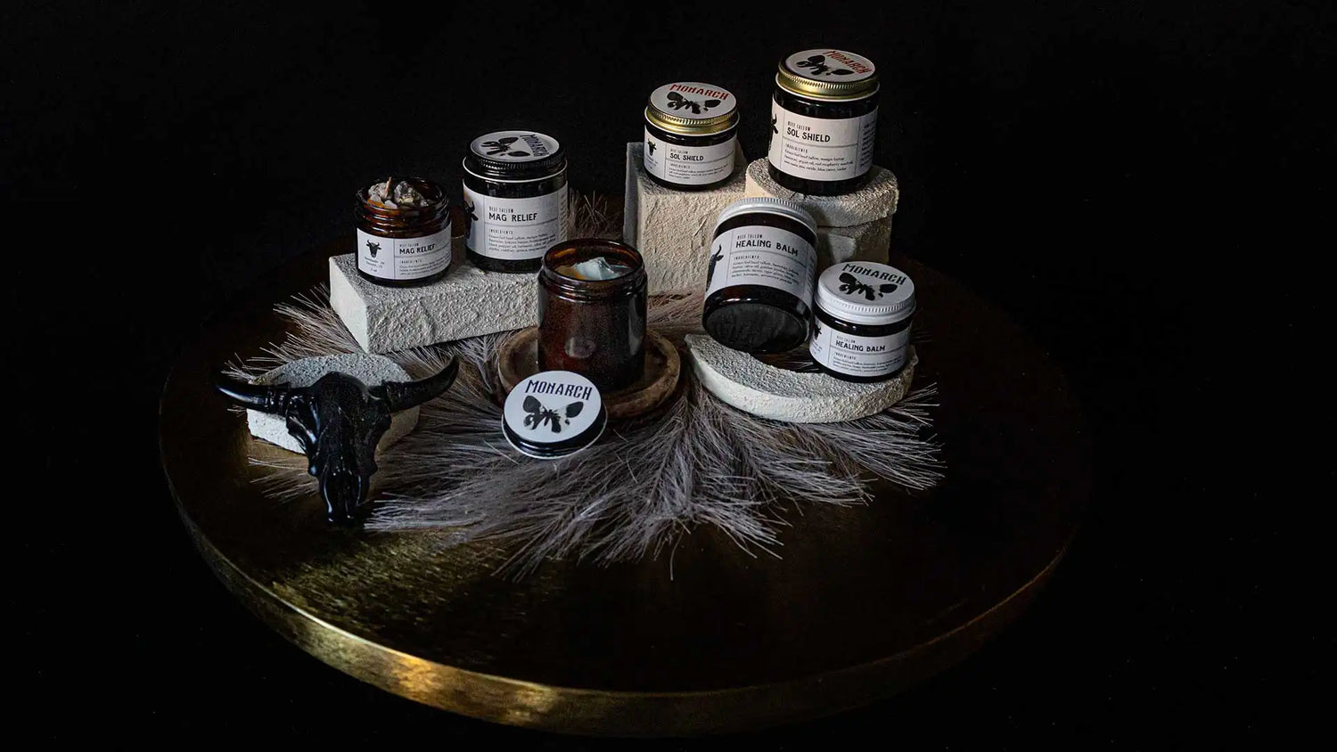 Collection of Monarch grass-fed beef tallow skincare products on a nice table display.