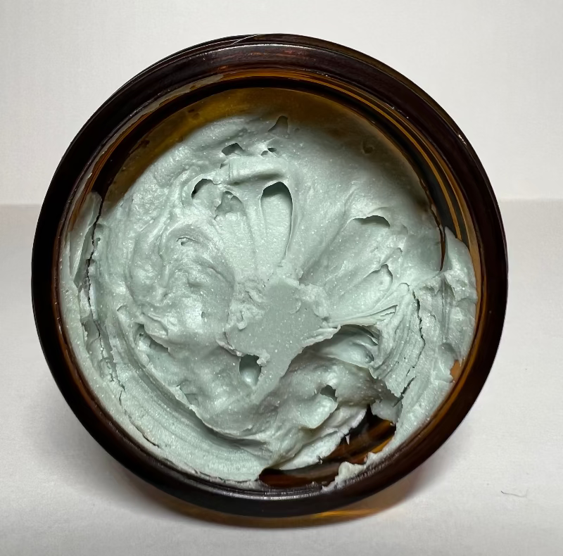 Top-down view of the grass-fed beef tallow Sol Shield in its open jar.
