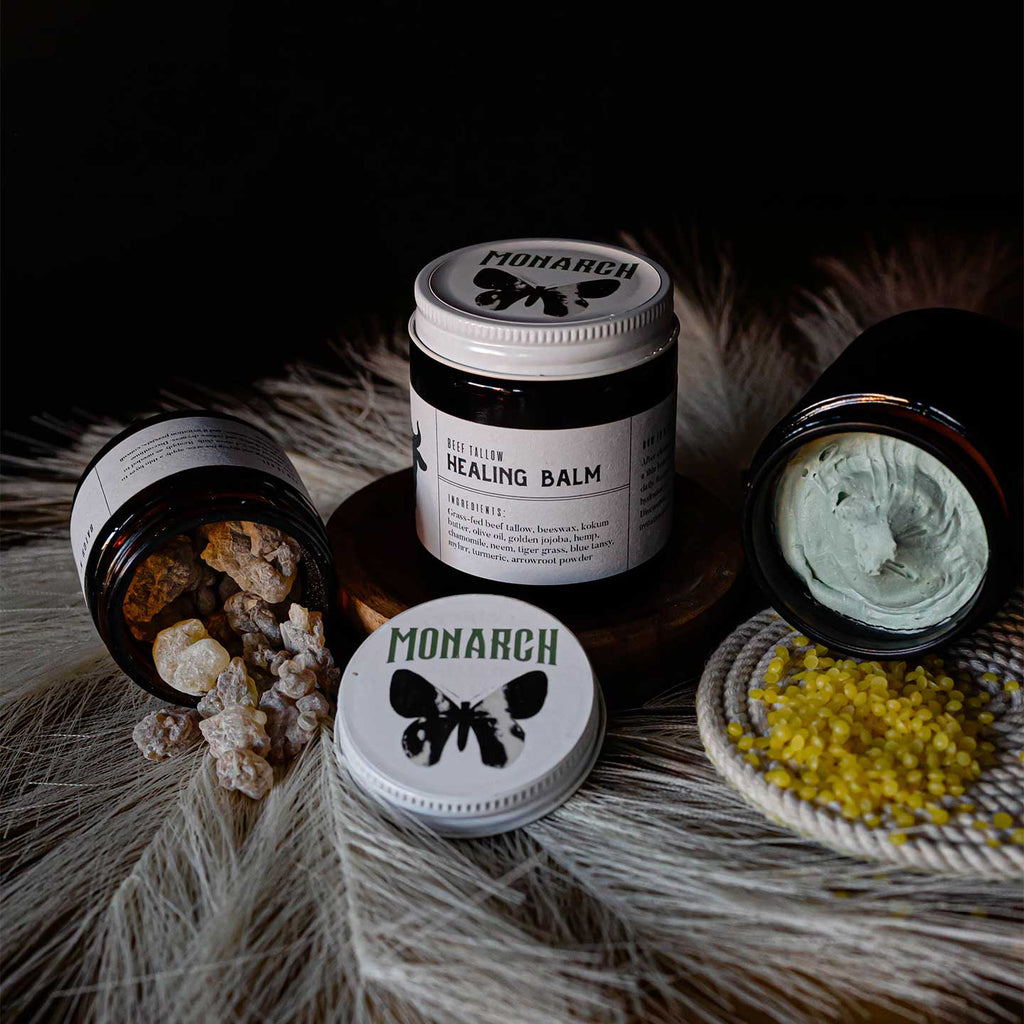 Grass-fed beef tallow Healing Balm product display with some featured ingredients.