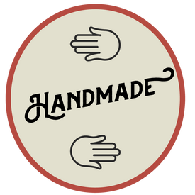 Icon symbolizing hand made feature with two hands and "HAND MADE" written in the center.